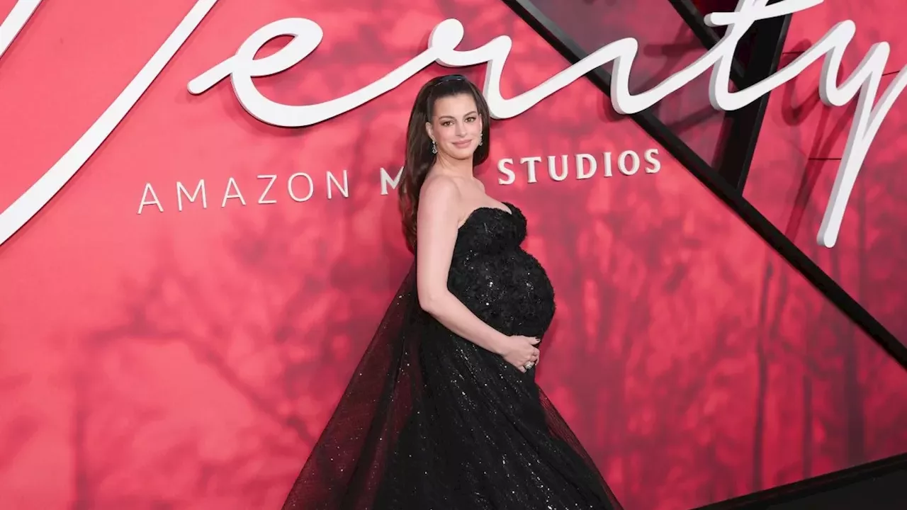 Anne Hathaway Shines on Red Carpet with Bump‑Celebrating Gown at New York Premiere