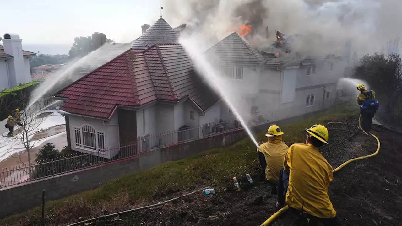 Southern California wildfire destroys homes as strong winds force evacuations